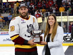 Hayley Moore, the AHL's vice-president of hockey operations, presents the Jack A. Butterfield trophy to Josh Leivo of the Chicago Wolves as the Calder Cup playoffs MVP. Leivo, a former OHL scoring star for the Sudbury Wolves and Kitchener Rangers and a Toronto Maple Leafs draft pick with 214 games in the NHL, scored 15 goals and assisted on 14 others during Chicago's 18-game run to the Calder Cup title.
