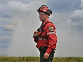 Aviation Forest Fire and Emergency Services Northwest Region Fire Advisor Jaime Seeley communicates with air attack aircraft near the drop zone during Saturday’s interagency training exercise. Photo courtesy of AFFES