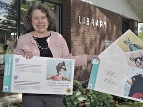 Marie Rosset, CEO of the Powassan and District Union Library, displays several of the boards from the latest Story Walk book sponsored by the TD Summer Reading Club. The library was one of 400 across Canada to get the laminated picture boards which can be seen and read July 2 and 9 at the Powassan Farmers' Market before relocating to Trout Creek later in July.
