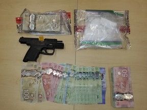 Cash, drugs and a firearm are seen after being seized by police through Project Renewal. Submitted