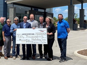 From left, Barry Dunlop, committee member; Mike Myatt, vice deputy mayor and committee co-chair; Rob Stanley, committee co-chair; Larry Dunn, Tim Blevins, Brad Pryde and Nicole Fraccaro, Summerside Hospitality and Luke Charbonneau, mayor, mark Holiday Inn's $50,000 donation top the Lamont Sports Park project.