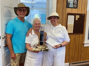 Brian Death of French Bay and Veronica Jackson of Sauble Beach are the winners of the Nellie Perry Tournament, held by the Saugeen Shores Lawn Bowling Club on June 22. Jean Morrison, Perry's daughter,  presents the trophy.