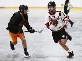Wallaceburg Red Devils' Riley Roe, right, is chased by Point Edward Pacers' Tyler Golden in the first period of an Ontario Jr. B Lacrosse League game at Wallaceburg Memorial Arena in Wallaceburg, Ont., on Saturday, June 4, 2022. Mark Malone/Chatham Daily News/Postmedia Network