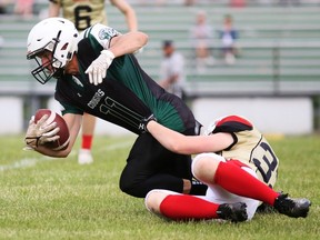 Chatham-Kent Cougars' Brett Wegrzyn is tackled by Guelph Jr. Gryphons' Zachary Van Hoffen during an Ontario Summer Football League varsity game at the Chatham-Kent Community Athletic Complex in Chatham, Ont., on Sunday, June 19, 2022. Mark Malone/Chatham Daily News/Postmedia Network