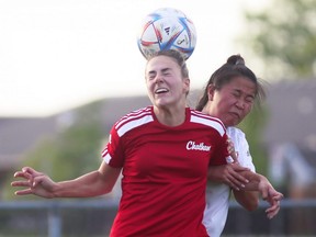 Chatham Strikers' Lucie Maine, left, heads the ball away from Jamie Chansamone of the London Serbian Club during a London & Area Women's Soccer League game at St. Clair College's Chatham Campus in Chatham, Ont., on Tuesday, June 21, 2022. Mark Malone/Chatham Daily News/Postmedia Network
