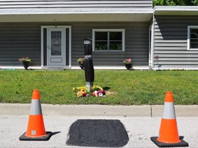 Neighbors on Delevan Crescent in Tillsonburg laid flowers in memory of a 54-year-old technician who they say fell to his death from a ladder Monday when he was working on utility wires in front of one of the homes.  Photo taken on Tuesday June 14, 2022. (CALVI LEON/The London Free Press)