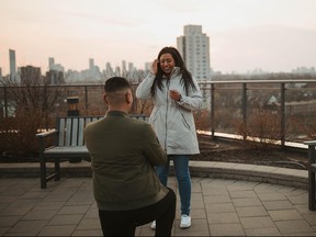 Man on bended knee proposing to happy girlfriend.