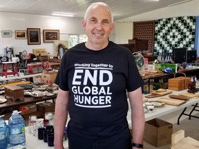Henry Reinders on Saturday, June 4, 2022 in Meaford, Ont., with items to be auctioned to support the Canadian Foodgrains Bank's drive ease a world hunger crisis. (Scott Dunn/The Sun Times/Postmedia Network)