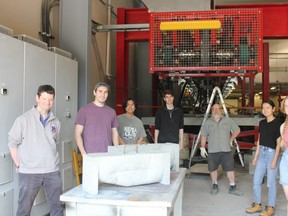 Cutline: Dr. Neil Hoult, pictured left, and his team show off their concrete demonstration blocks in the Queen's Civil Engineering Laboratory. Aidan Chin photo
