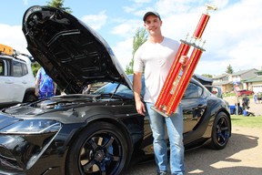 CJ Quinton holds his People’s Choice Award next to his 2021 Toyota Supra at Fort City Church’s father’s day car show in Fort McMurray, Alta. on Sunday, June 19, 2022. Vincent McDermott/Fort McMurray Today/Postmedia Network