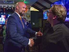 Terence Kernaghan is congratulated by Matt Nicolaidis at Wink's in downtown London on Friday June 3, 2022. Kernaghan was re-elected as MPP in London North Centre. (Derek Ruttan/The London Free Press)