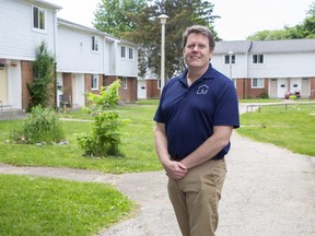 Paul Chisholm, chief executive of London and Middlesex Community Housing (LMCH), stands at a townhouse complex on Southdale Road and Millbank Drive where the agency is razing about 18 townhomes so it can build an apartment building to house more tenants. Photo taken Friday, June 3, 2022. (Derek Ruttan/The London Free Press)