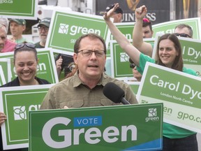 Green Party Leader Mike Schreiner speaks during a London campaign stop with London North Center candidate Carol Dyck, right, at Oxford Street and Wharncliffe Road on election eve Wednesday.  (Mike Hensen/The London Free Press)