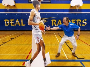 Todd Woollings, the principal at H.B. Beal secondary school in London, jokes around with a cardboard cutout of former Raiders star Shaedon Sharpe, now a member of the Portland Trail Blazers after being picked seventh overall in the NBA draft. Photograph taken on Friday June 24, 2022. (Mike Hensen/The London Free Press)