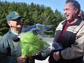 Terry Smith (left) and Ross McIntosh share a laugh during a brief ceremony June 18 honouring Smith's 50-years running the concession booth in Fullarton. McIntosh was on the Fullarton Parks Board when the decision was made to hire her, along with her late husband Bruce, and presented her flowers to signify her retirement. ANDY BADER/MITCHELL ADVOCATE