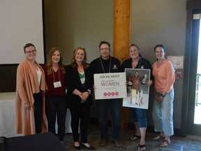 The 100 Airdrie Women Who Care take a celebratory photo with John Langenau and Betina Fillion of the Kalix Legacy Foundation following their vote on June 7. Photo by Riley Cassidy/The Airdrie Echo/Postmedia Network
