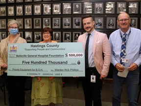 The Belleville General Hospital Foundation's Jan Summers, left, and Steve Cook, second from right, accept Hastings County council's $500,000 cheque from county finance committee chair Jo-Anne Albert and Warden Rick Phillips Tuesday in Belleville. The funds will help to replace nuclear medicine cameras.
