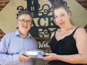 Neil Kerby, a Professor and Coordinator of the Community and Justice Services program at Loyalist College, receives a cheesecake from Amanda Jarvis, owner of Double Mm.. Cheesecakes and a recent graduate from rom Loyalist CollegeÕs Community and Justice Services program. Jarvis attributes her success in the program to Kerby's help. ALEX FILIPE