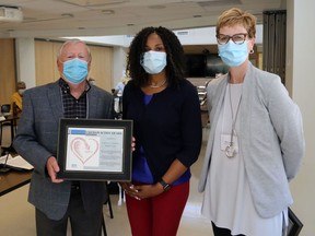 Quinte Health Care treasurer John Kearns and chairperson Nancy Evans flank Belleville nurse practitioner and clinic director Karen Clayton-Babb Tuesday at Belleville General Hospital. She accepted the QHC board's appreciation award on behalf of Belleville Nurse Practitioner-Led Clinic.