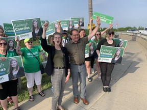 Brantford-Brant Green Party candidate Karleigh Csordas and Ontario Green Party Leader Mike Schreiner wave to motorists near the Lorne Bridge in Brantford on  Wednesday morning. Voters go to the polls on Thursday. Vincent Ball