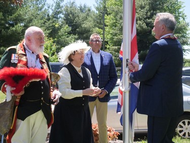 The Union Jack is raised Saturday afternoon at the Bell Homestead during Brantford's Queen's Platinum Jubilee Celebration. From left are town crier David McKee, Sarah Hamilton, homestead education co-ordinator; Will Bouma, Brantford-Brant MPP-elect and Brantford Mayor Kevin Davis. CHRIS ABBOTT