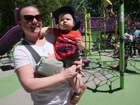 Brantford's Linsay Way celebrates the grand opening Saturday of Mohawk Park's new playground with her one-year-old son, Kalin. CHRIS ABBOTT