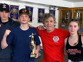 Jackie Armour, Brantford Black Eye Boxing Club coach, poses with boxers Tommy Wallace (left), Liam Welch and Kelsie MacPhee. Submitted