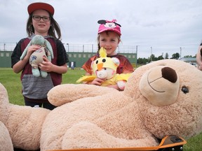 Henry (left) and Tanner Morrison brought their stuffed toys, Bunny, Not Named Yet and The Big One, to Sunday's Kiwanis Teddy Bear Picnic in Paris for an afternoon of games and activities. CHRIS ABBOTT