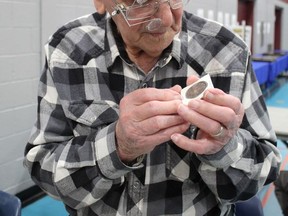 Ninety-nine-year-old Bill English checkd out a coin at the 59th annual Brantford Numismatic Society coin show on Sunday. He started collecting coins when he was a boy. Michelle Ruby