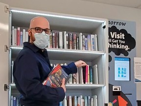 Gary Jermy, co-ordinator of outreach and community impact with the County of Brant Public Library, demonstrates how to use the new book-lending kiosk at the new Onondaga fire station.