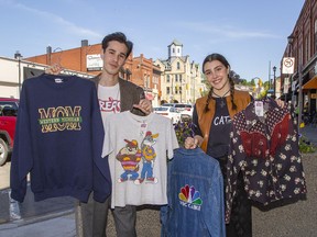 Harrison Snyder and Quinn VanMackelberg show some of the vintage clothing that will be available from more than 40 vendors during the Memory Lane Market on June 25 and 26 in downtown Paris.