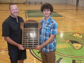 Expositor sports editor Brian Smiley presents the Ed O'Leary Memorial Award for male student athlete of the year to Jaden Chagnon of St. John's College.