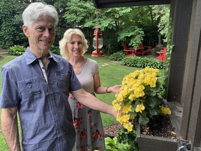 Jim and Alison Telford check out the flowers in the backyard of a Devon Street home as part of the Grand Erie Master Gardeners gard tour on Sunday. The tour, which returned for the first time after a two-year COVID-19 pandemic hiatus, included seven gardens in Brantford and two in Paris. Vincent Ball