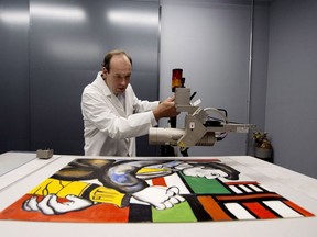 A painting purportedly by French master Fernand Leger is searched for signs of forgery at the Fine Arts Experts Institute in Geneva. Richard Juilliart/AFP/Getty Images