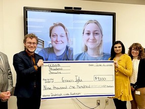 From left, chairman John McAllister (partially hidden), student trustee Bradford Ward, (on screen) Green Iglu CEO Raygan Solotki, (on screen) Green Iglu director of marketing Paige Deasley, student trustee Eshal Ali, and superintendent of schools Jennifer Perrypose with a cheque representing money raised by students in April for remote Indigenous communities. (SUBMITTED PHOTO