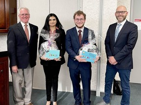 Upper Canada District School Board chairman John McAllister, far left, and director of education Ron Ferguson, far right, presented student trustees Eshal Ali, second to left, and Bradford Ward with a parting gift during their final board meeting of the 2021-22 school year Wednesday evening. (SUBMITTED PHOTO)