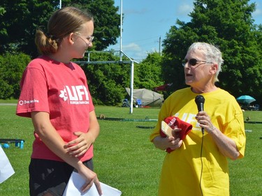 Alison Eyre (left) hands the microphone to cancer survivor Nancy Purvis at the TISS Relay for Life opening ceremony.
Tim Ruhnke/The Recorder and Times