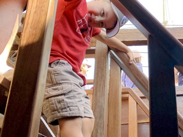 Brady McMillan, 4, of Maxville, climbs down the steps to the hold of the Nao Trinidad on Saturday. (RONALD ZAJAC/The Recorder and Times)