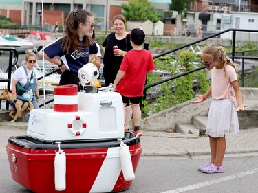 Six-year-old Nyah White takes no bull from Crash, the Aquatarium's robot, which was being chaperoned on Blockhouse Island by Jordan Ross, left. (RONALD ZAJAC/The Recorder and Times)
