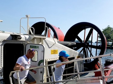 The massive propellers of the Canadian Coast Guard amphibious hovercraft CCGS Mamilossa loom in the background as Valery Kravtsov, of Ottawa, and his daughter Angelika leave the ship after a tour. (RONALD ZAJAC/The Recorder and Times)