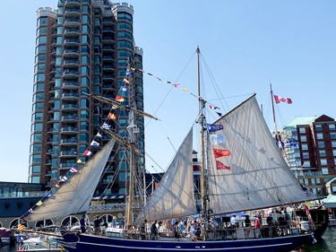 The sail training vessel TS Playfair is mobbed with visitors Saturday as it sits docked by the Tall Ships Landing condominium tower, next to the Fair Jeanne. (RONALD ZAJAC/The Recorder and Times)