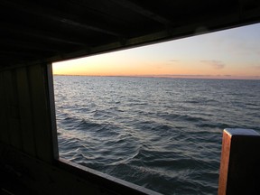 It's just before 7:25 a.m., Tuesday, March 29, 2022, eight miles due south of Kingsville, aboard the Lady Anna II. Looking east, through the port bow hatch. On the horizon, across nine miles of frigid water, is the west shore of Point Pelee. John Martinello photo