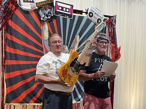 Children's Treatment Centre Foundation of Chatham-Kent president Mike Genge (left) and auctioneer Greg Hetherington, are seen here during the live auction portion of the 21st annual Festival of Giving, which raised $160,800 on June 25. Handout