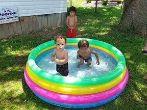 An extreme heat warning issued by Environment Canada on Wednesday sent many people inside seeking air conditioning as the temperature soared to 37 C with a scorching humidex that felt like 46 C. However,  Jahmal Sambury, 1, left, of Chatham, and his brothers Jah, 2, right and A.J., 3, in back, found a fun way to beat the heat by splashing around in their pool.