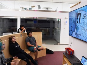 Wallaceburg District secondary school students Sunny Gamble, Elora Knight-Williams, Jayden Williams and Ty Williams, back, watch an episode of Gravity Falls at the school's student hub on Wednesday.  (Tom Morrison/Postmedia Network)