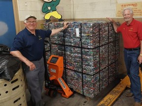 Achom Shrine Club members Gary Eagleson, left, and Terry Maynard display one of the bundles of crushed pop cans that will be sent to a smelter in Kentucky with the proceeds going to the Shriner's Hospital for Children in Montreal. (Ellwood Shreve/Chatham Daily News)