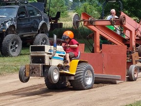 Liam Marsh, 11, of Bothwell, was going for it in the tractor pull competition at the Thamesville Threshing Festival on Saturday. He pulled an impressive 200.63 feet on this ride. PHOTO Ellwood Shreve/Chatham Daily News