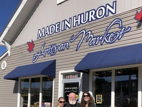A project to place flower pots outside downtown businesses in Clinton is honouring the late Sandra Garnet of the Made in Huron Artisan Market. Garnet was a prominent member of the community and also served as the chair of the Central Huron Business Improvement Association for the last several years. Pictured from left with one of the new planters are Joyce Ridder, Brian Garnet and Angela Smith. Handout