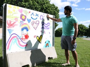 City Coun. Justin Towndale painting on the community colouring wall in Lamoureux Park on Saturday May 28, 2022 in Cornwall, Ont. Laura Dalton/Cornwall Standard-Freeholder/Postmedia Network