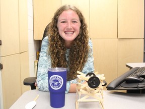 Iona Academy student Nuala Gibbs, with prototypes of her national award-winning science project, and a beverage container from the prestigious prep school she'll soon be attending in New England. Photo Thursday, June 2, 2022, in St. Raphael's, Ont. Todd Hambleton/Cornwall Standard-Freeholder/Postmedia Network